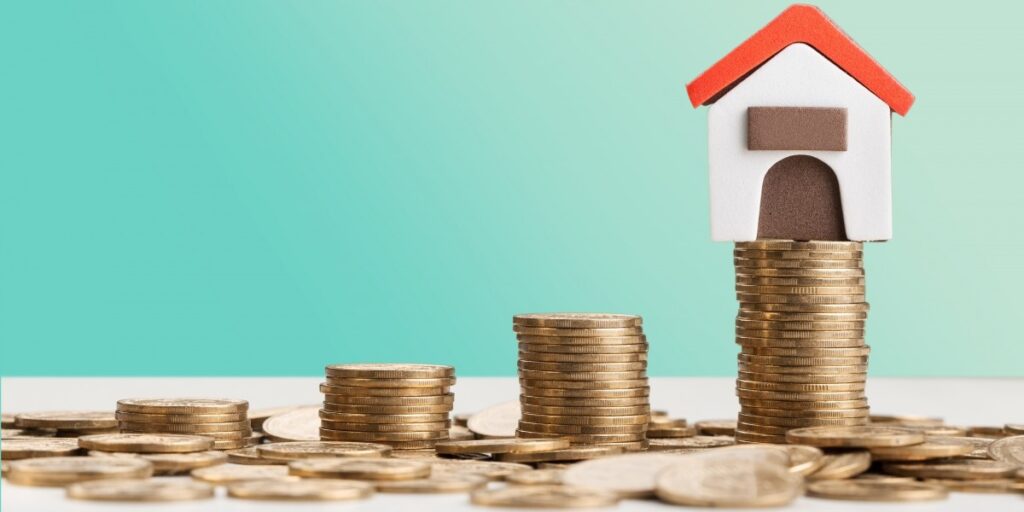 stack of coins with house on top