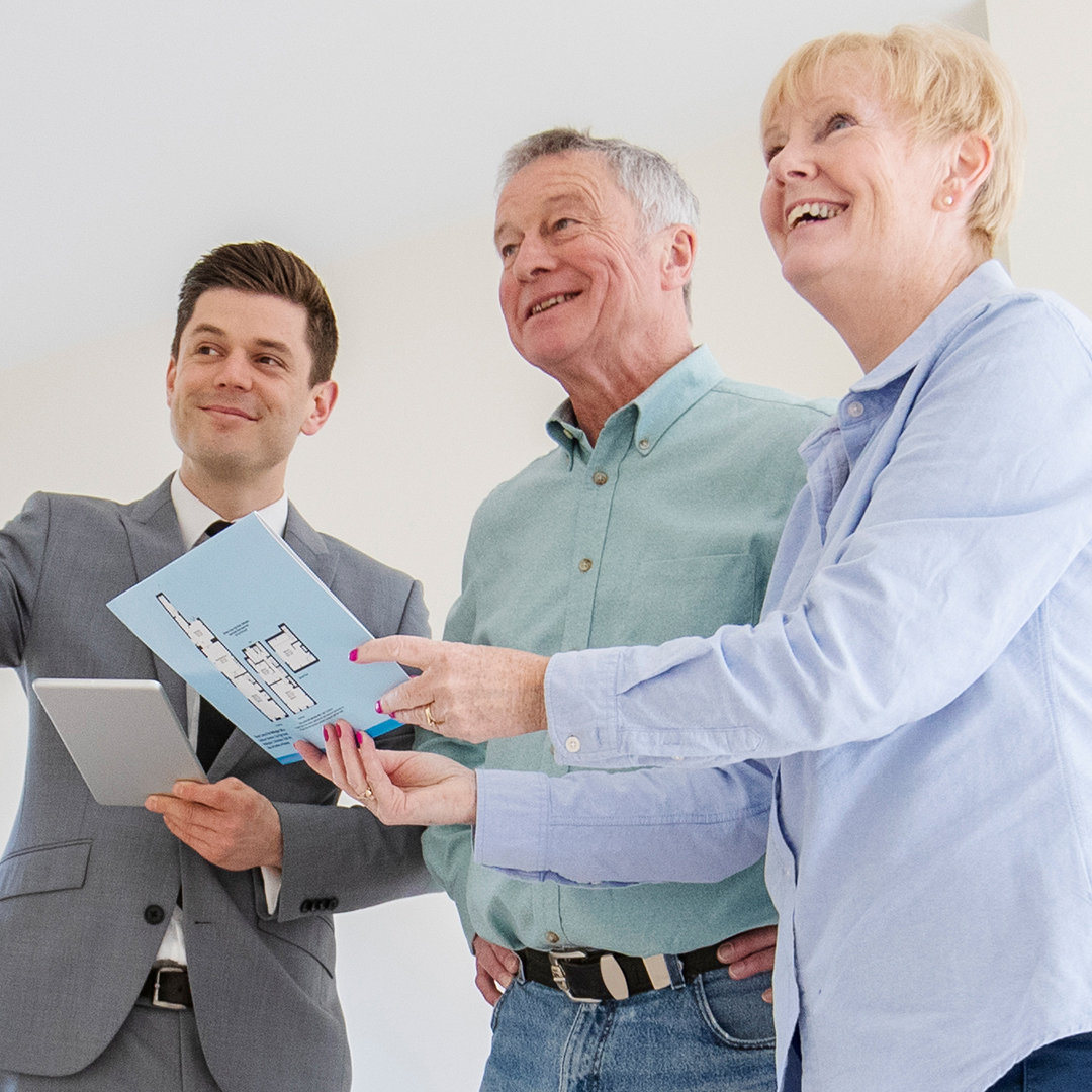Image of a realtor with an elderly couple