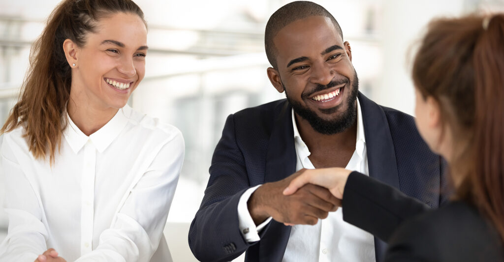 Image of young couple meeting with their realtor