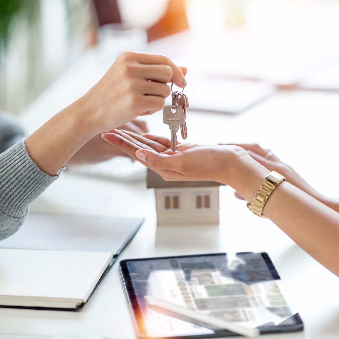 real estate agent giving client keys to home