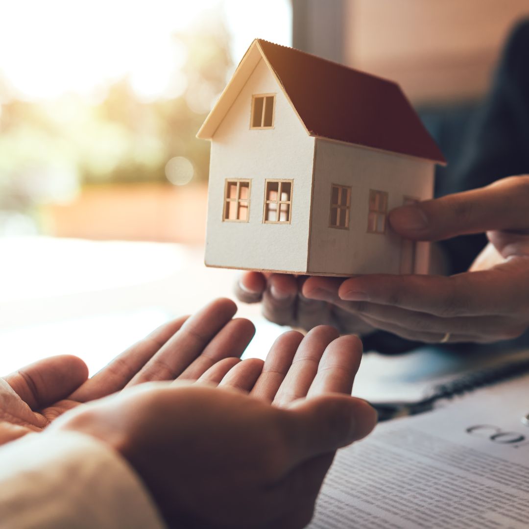 holding small model house