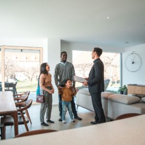A family looking at a house with a realtor