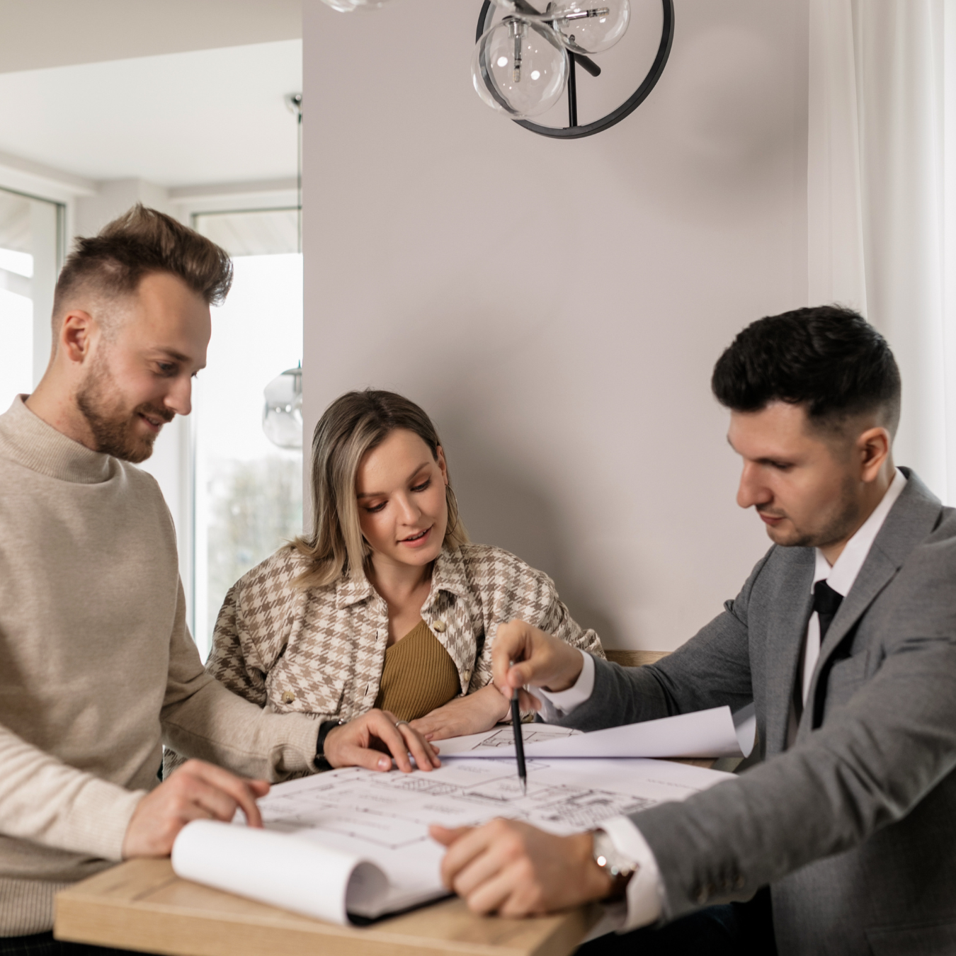 A couple speaking to a real estate agent