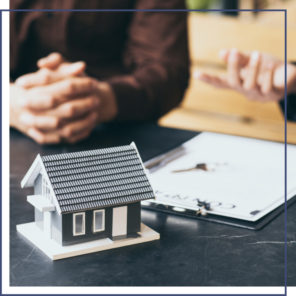 Real estate team consulting over house