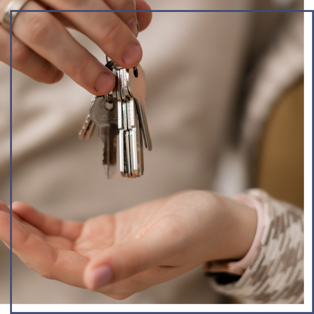 Real estate agent handing off keys to homebuyer