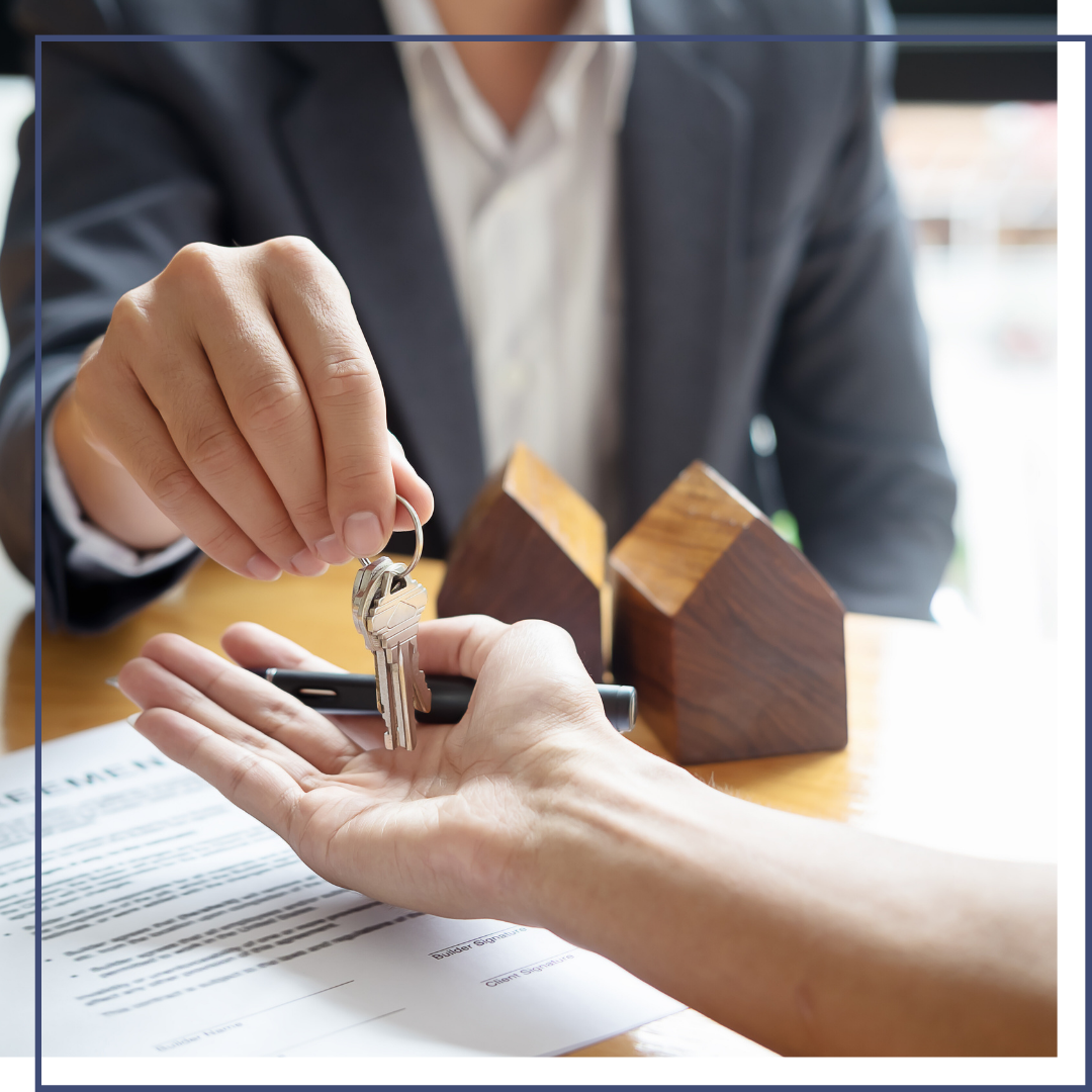 Real estate agent handing over keys