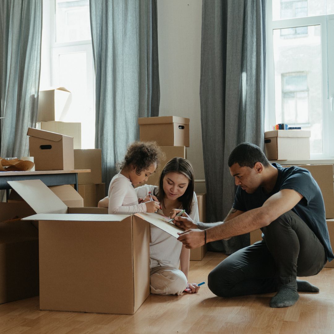 family unpacking boxes